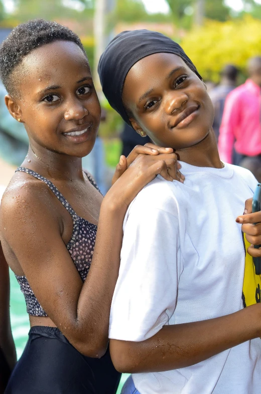 two s in bathing suits posing for the camera