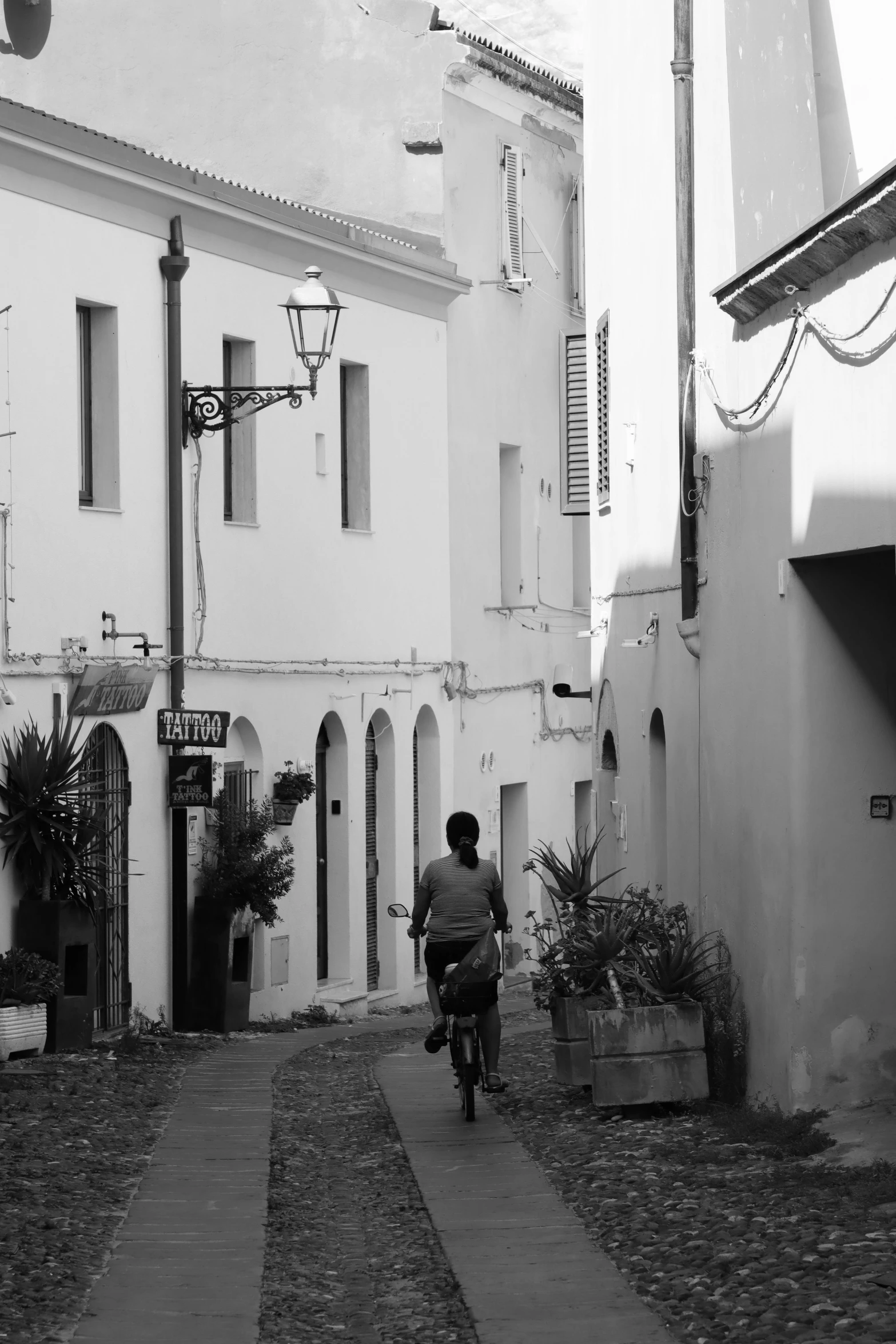 a person rides a bike past an old building