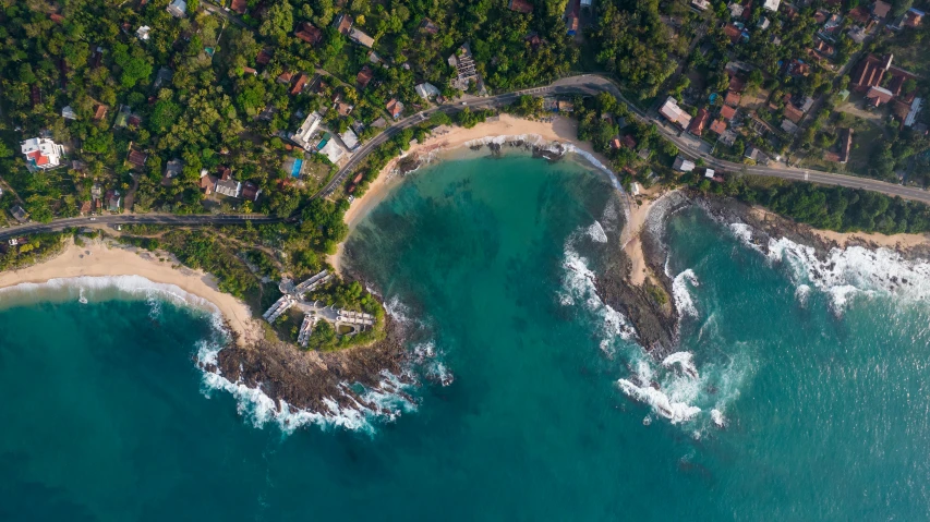 an aerial view of the ocean near a residential development