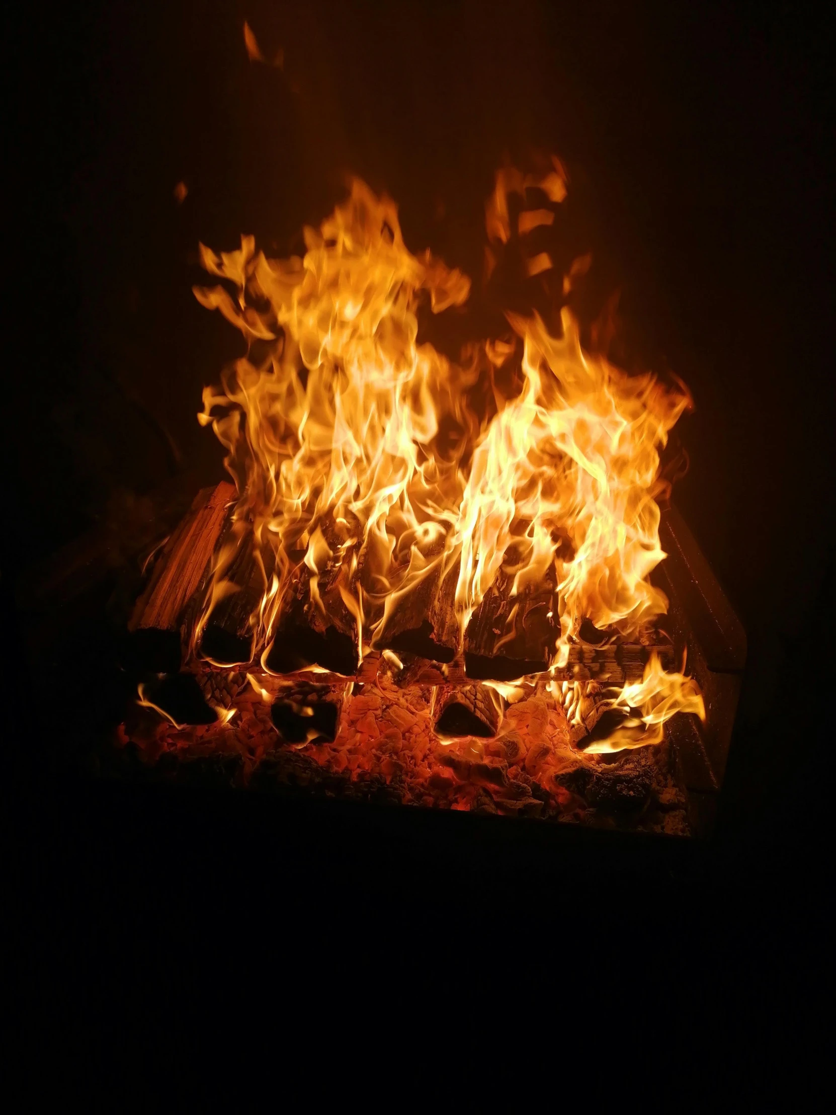 a large fire burning inside of a wooden oven