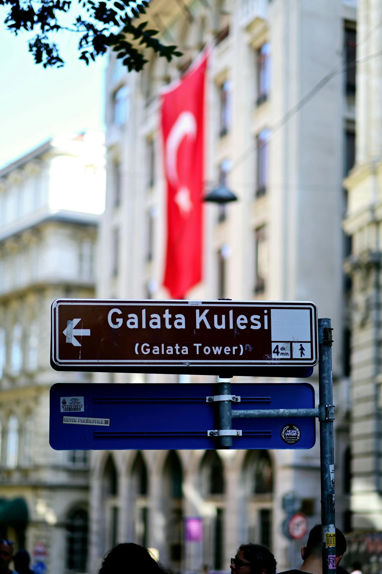 a sign sitting on the corner of a city street