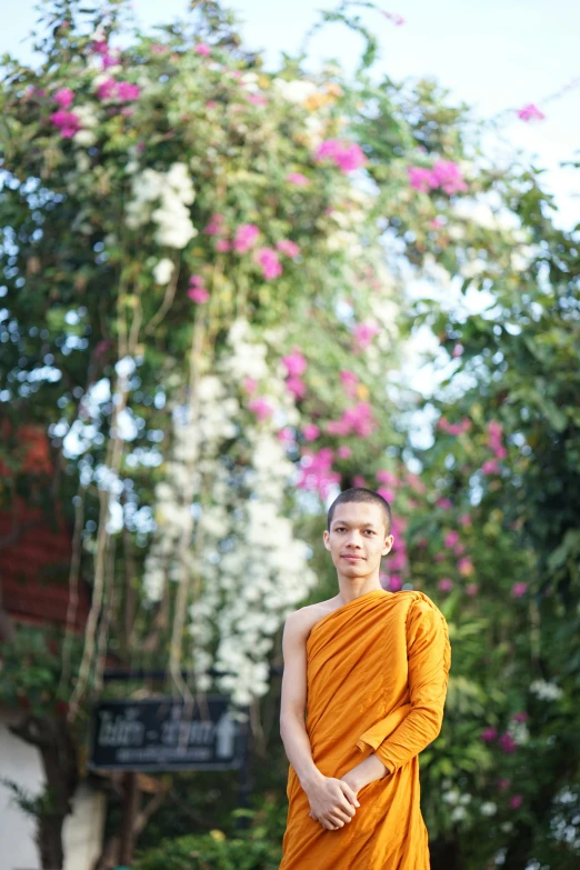 the young monk is posing for the camera