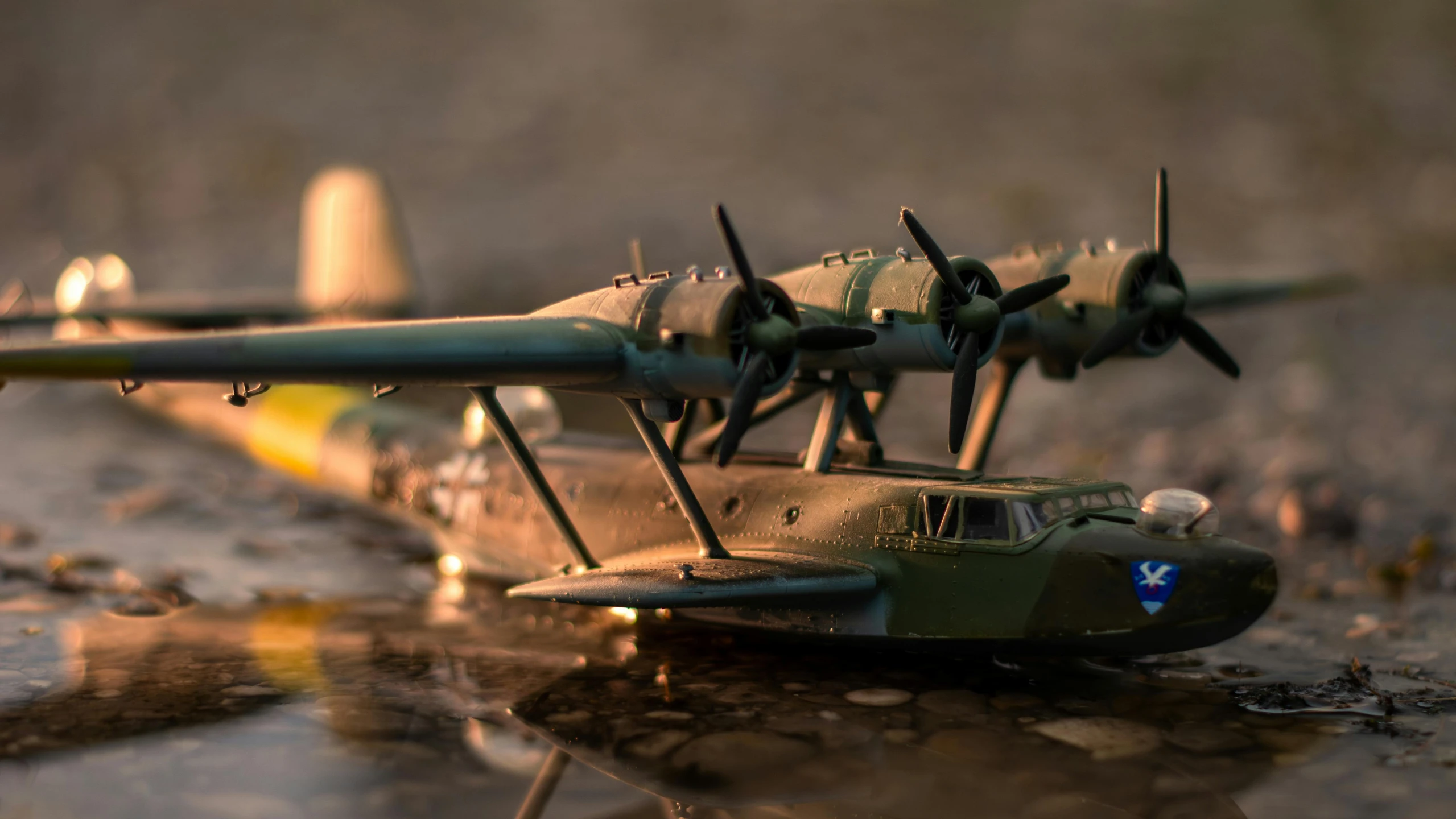 small army aircraft model on wet surface near dles