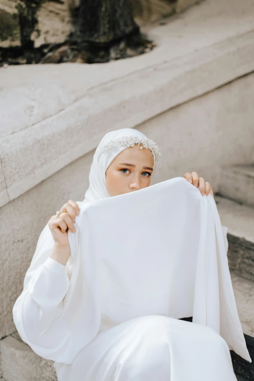 a woman in a hijab poses for the camera with her veil on