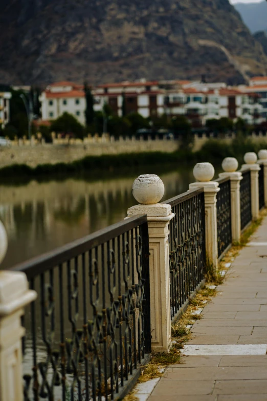 a road with many lamps that is next to water