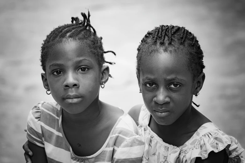 two children are posing for the camera