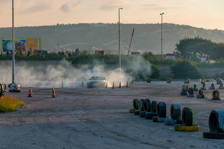 smoke pouring out of the hoods of a car