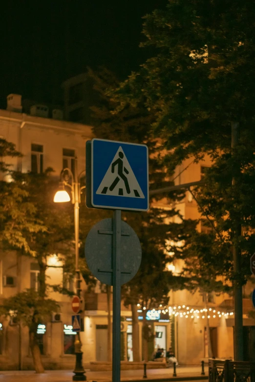 street signs on a pole near the road