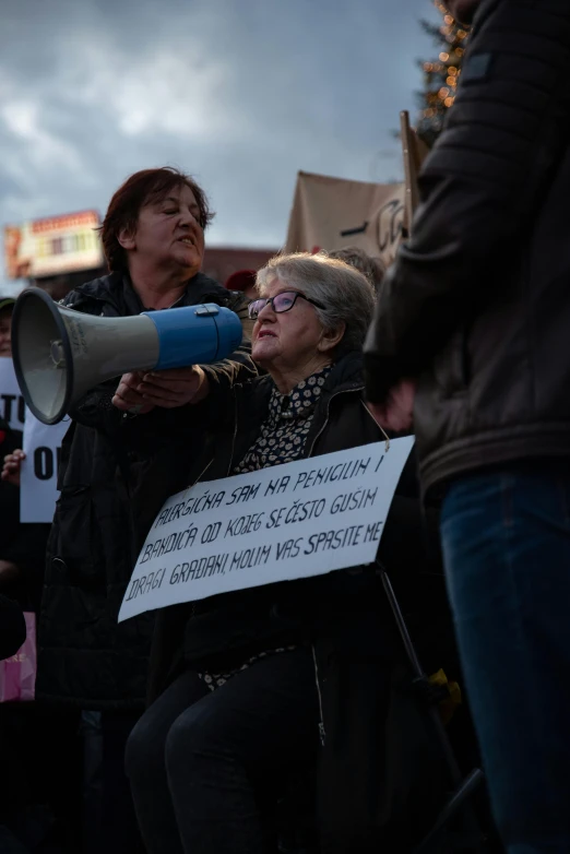 a person shouting into a large blue bull horn