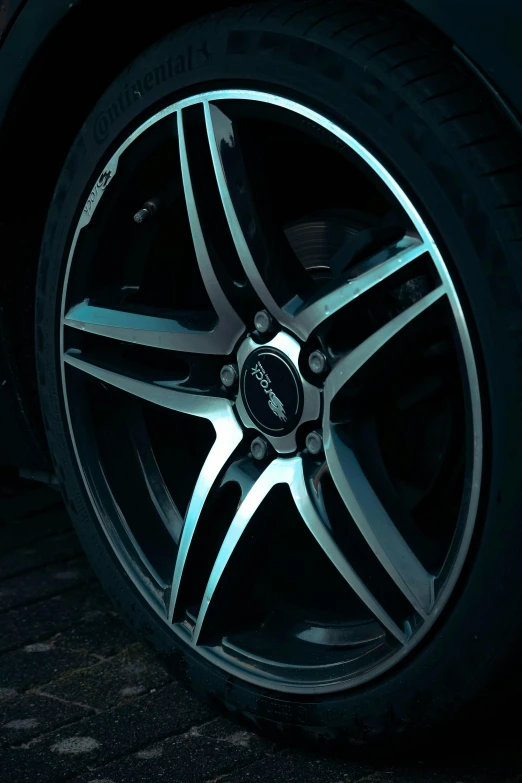 a wheel is glowing in the dark on a street