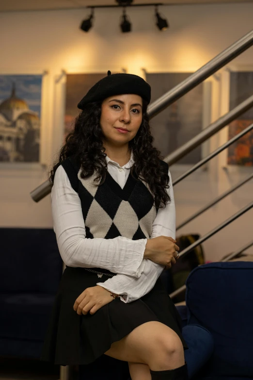 a woman is posing for a picture by some stairs