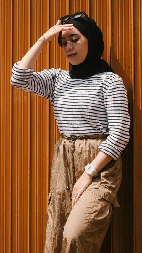 a woman in brown pants and shirt looking through the glasses