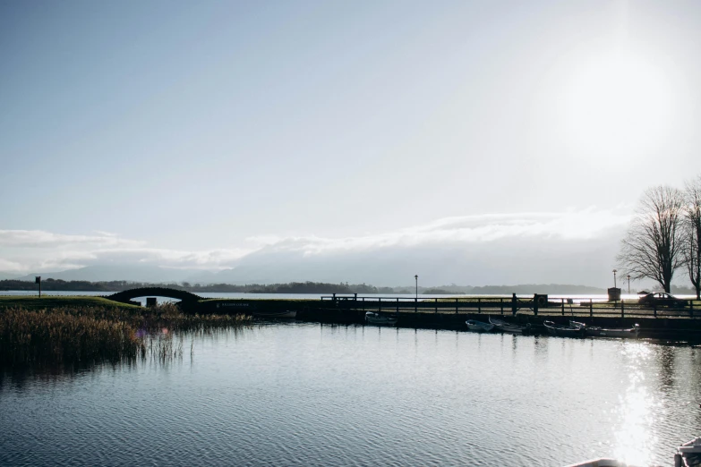 a pier with two canoes is on the water