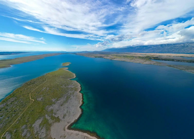 a landscape view of a lake surrounded by land and water