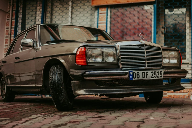 a dirty car parked on a city street