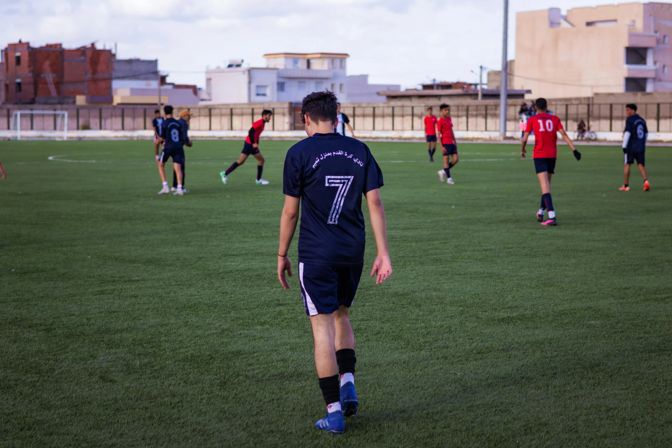 a soccer player standing on the field with his head down