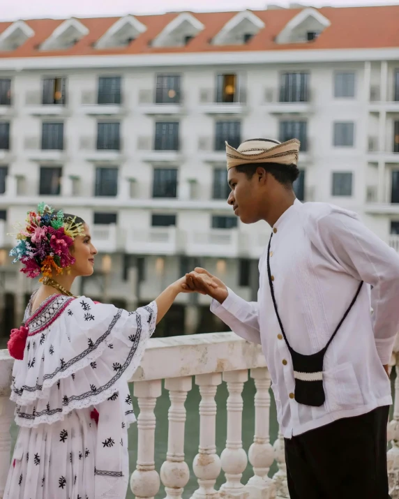 an image of a couple in costume on the balcony of a el