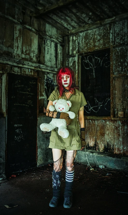 a woman dressed as an orange haired girl holding a stuffed animal in an abandoned building