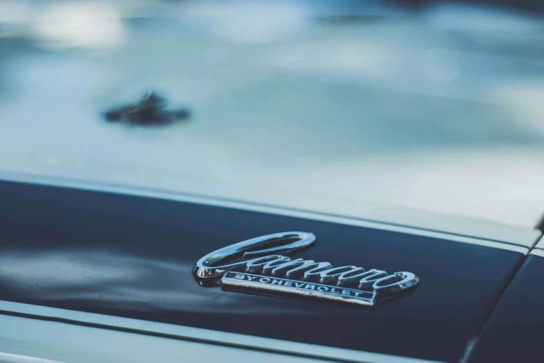 a closeup view of a black car with its emblem