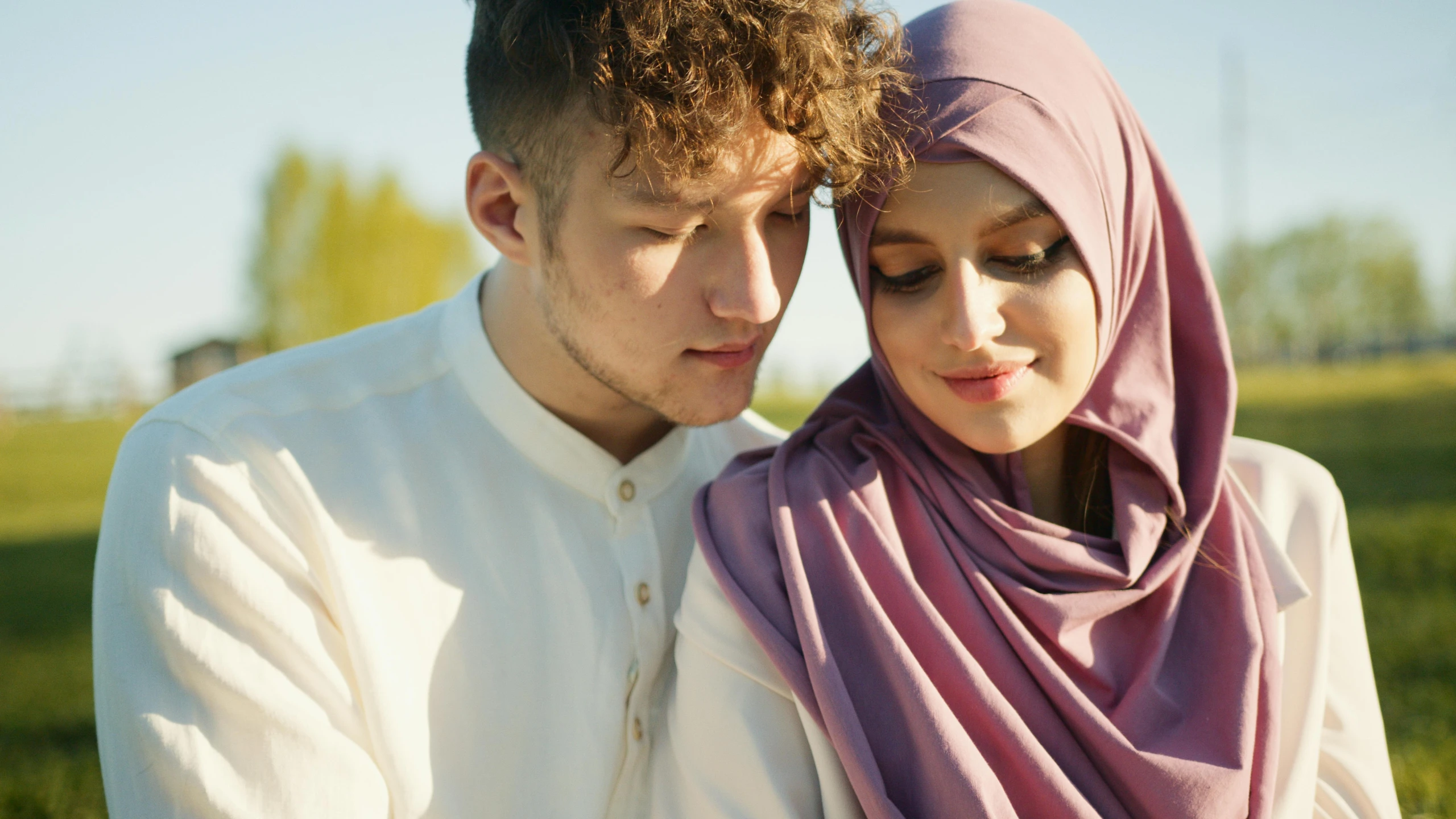 a young man and woman holding each other