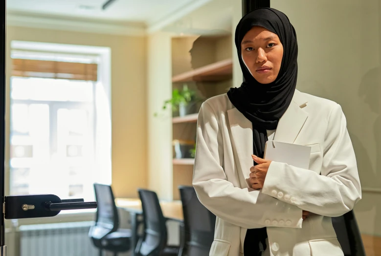 woman standing by a desk in an office building