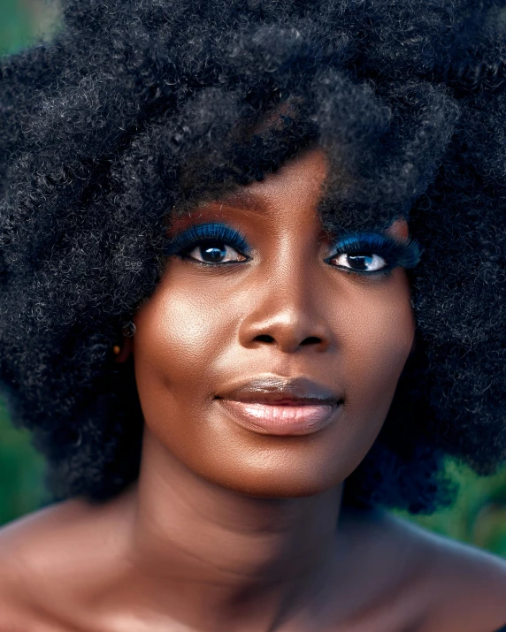 an african woman with natural hair wearing blue