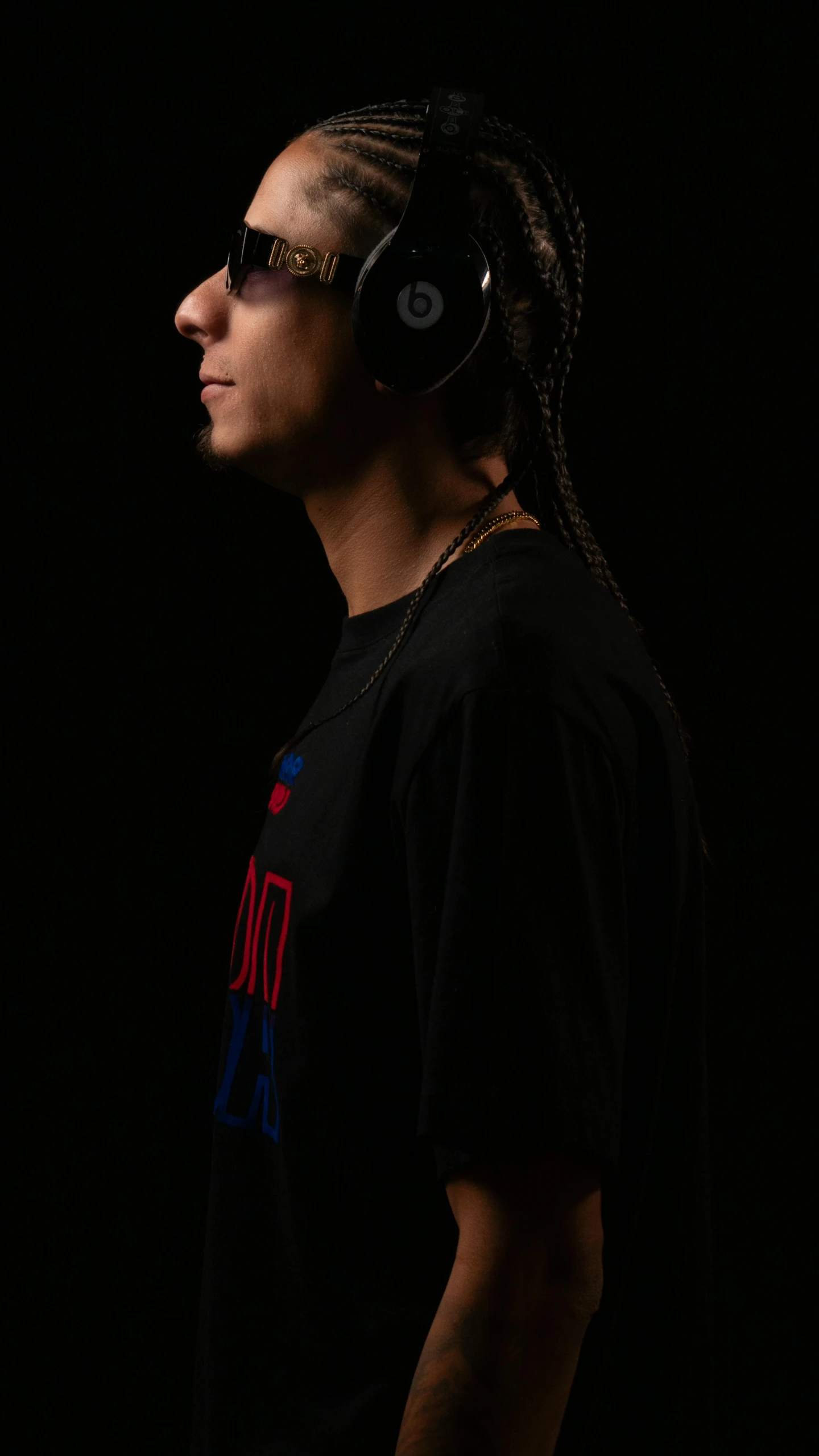 a young man with dreadlocks and sunglasses wearing headphones