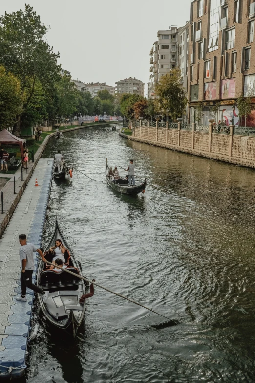 boats are lined up along the water by buildings