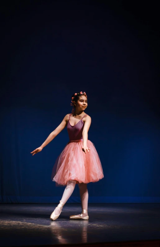 a girl dressed in a tutu and ballet shoes is performing
