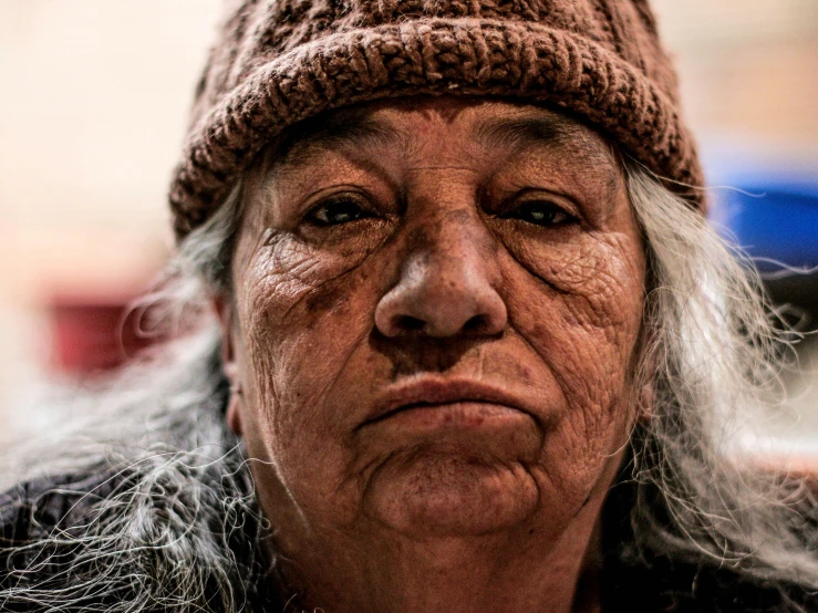 a close up view of a woman wearing a hat and jacket