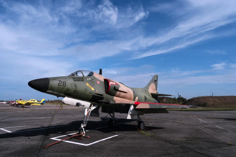 a fighter jet sits on an airport tarmac