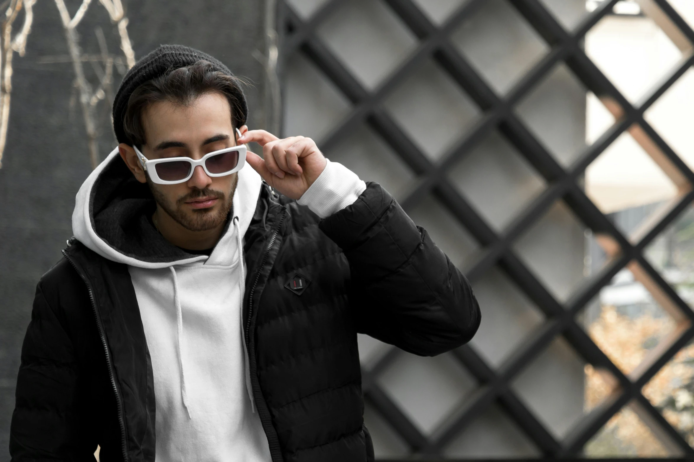 a young man in the city wearing sunglasses