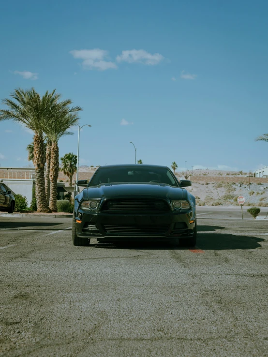 the black car is parked in the lot