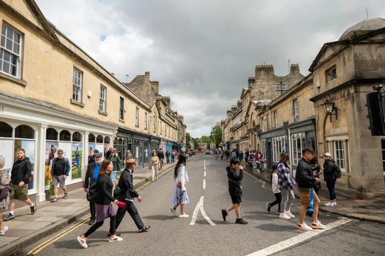 people crossing the street in an old - fashioned town