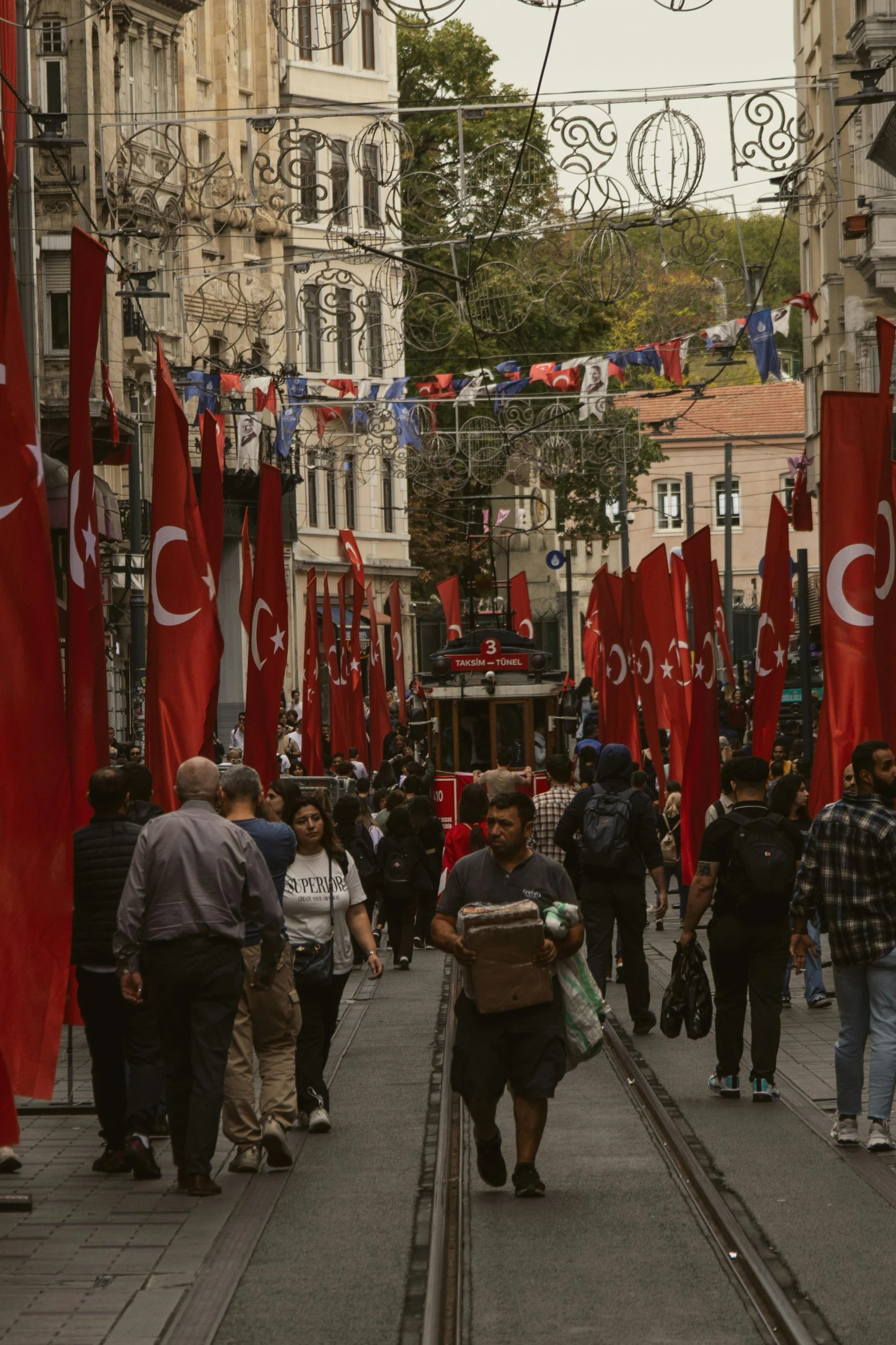 a group of people walking along a busy city street