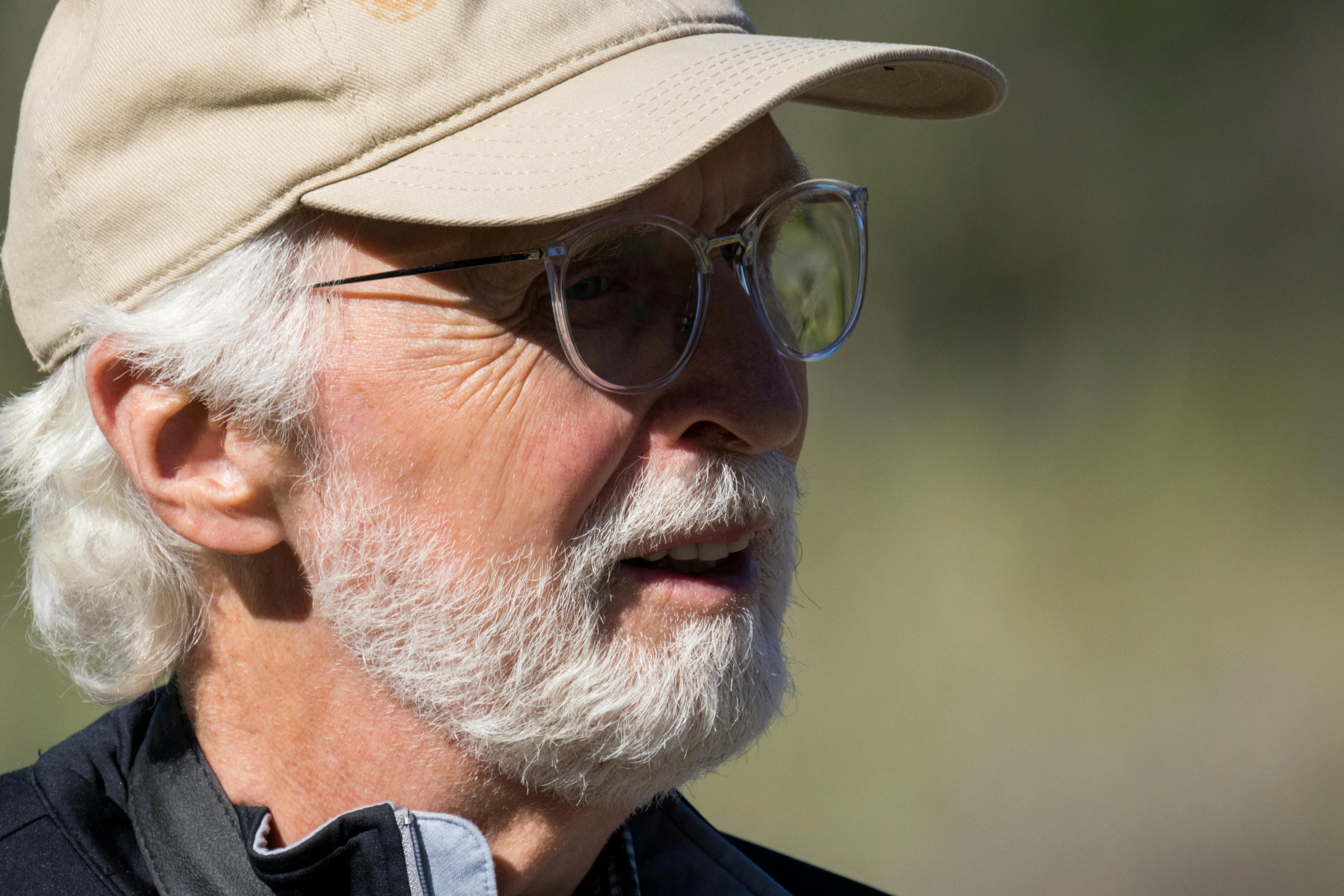 an older man with a cap and glasses