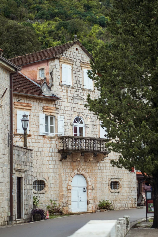 an old stone building with a tree next to it