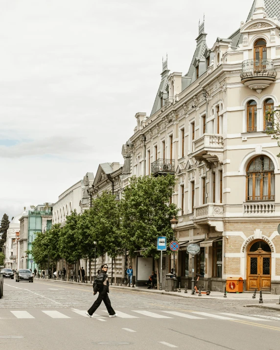 a man crosses the street at a pedestrian crossing