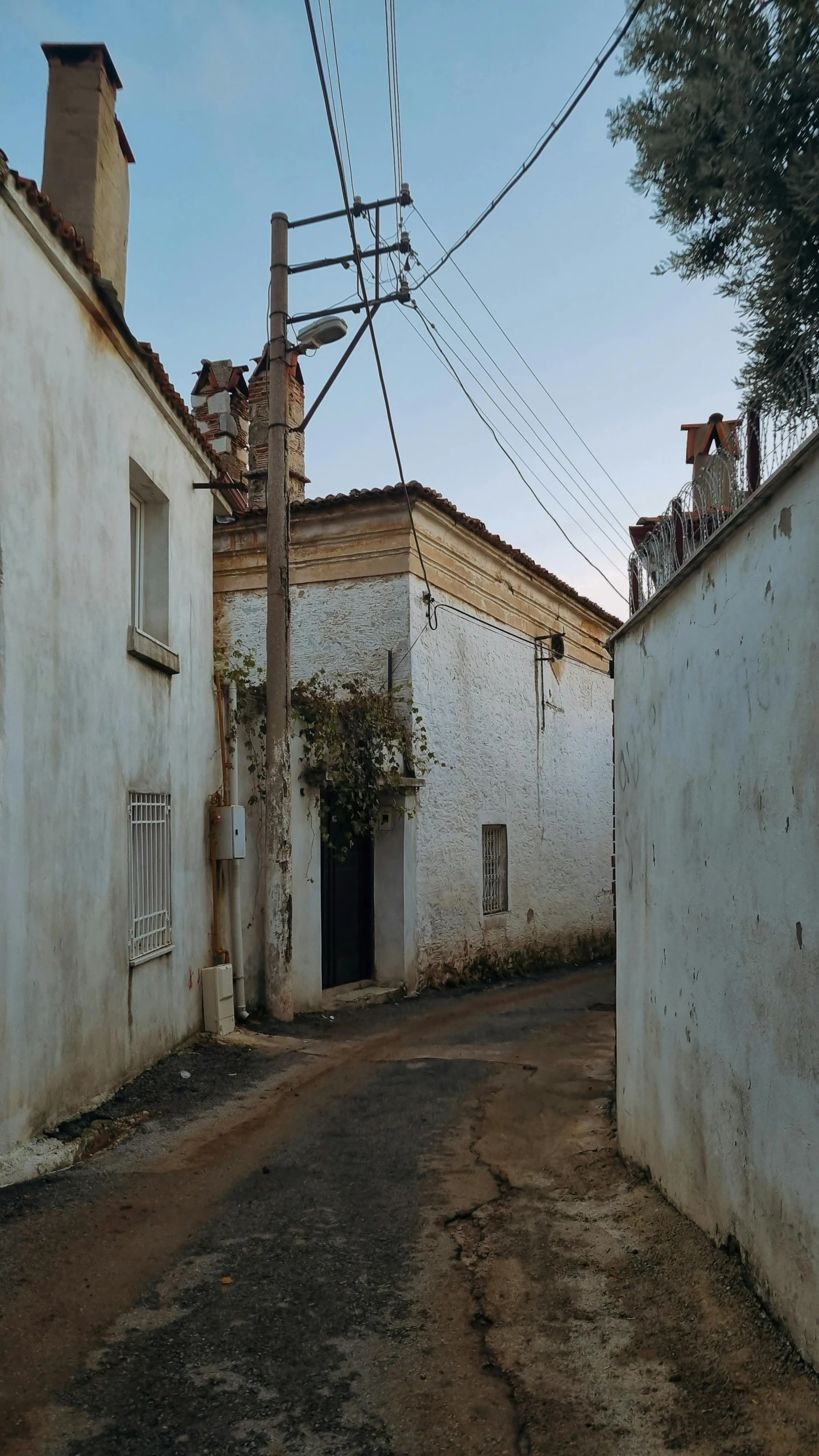 a small alley with telephone wires above it