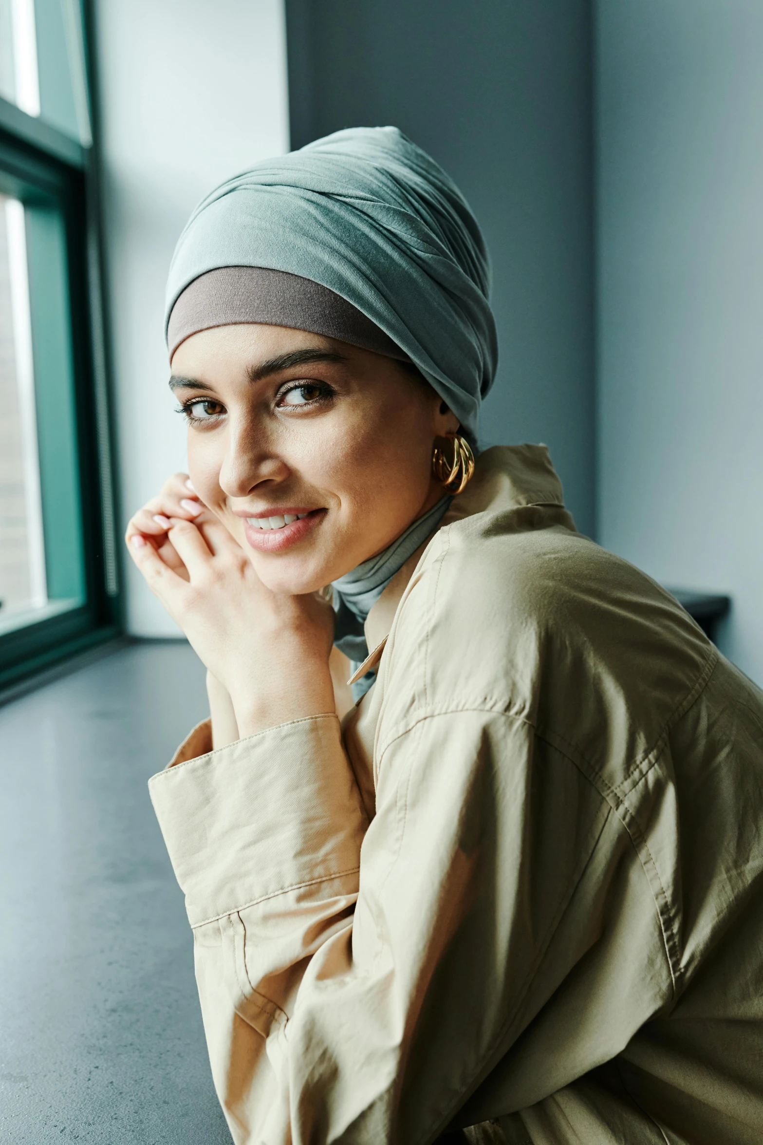 a beautiful woman with a blue turban is smiling