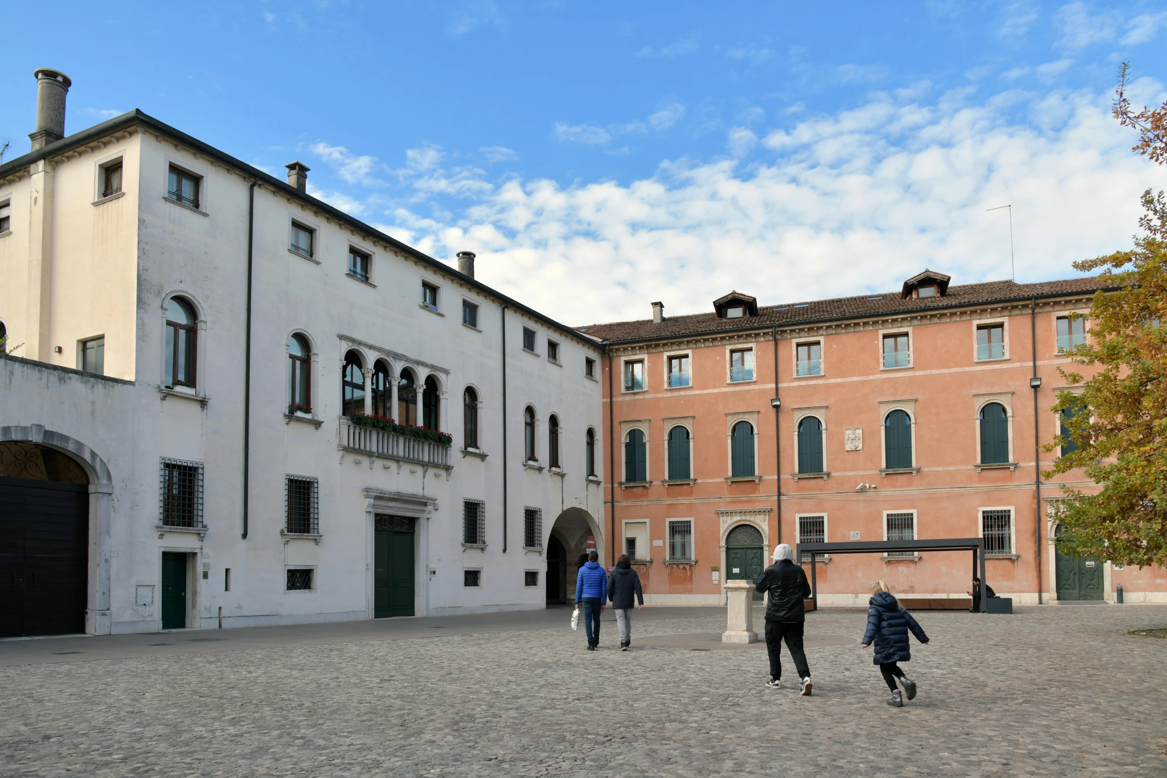 two people standing outside in front of a building