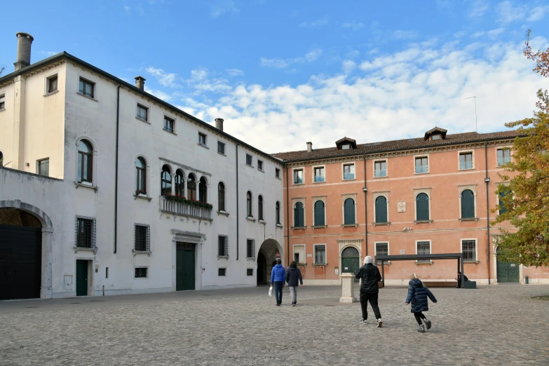 two people standing outside in front of a building