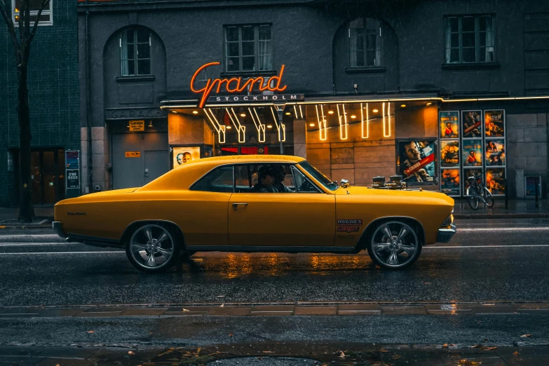 a yellow car parked in front of an establishment