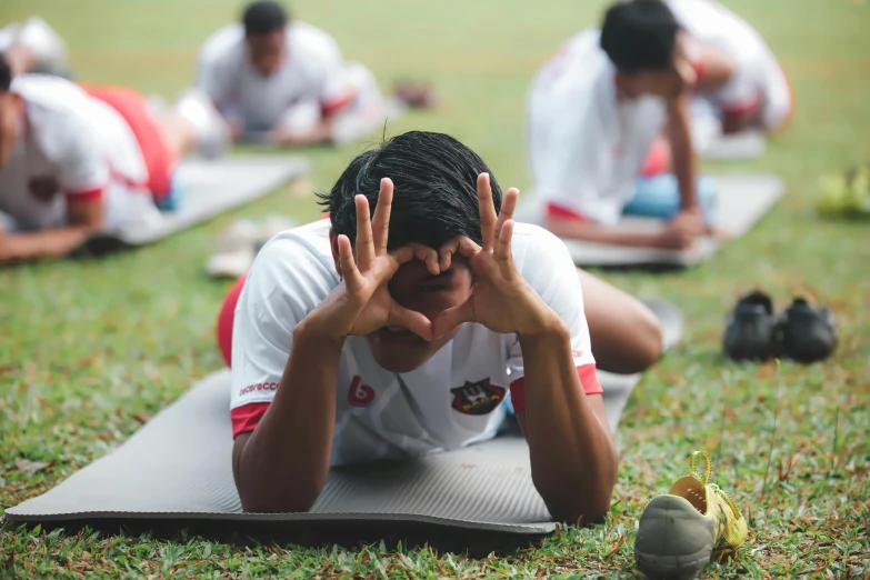 a group of people who are doing yoga in a park