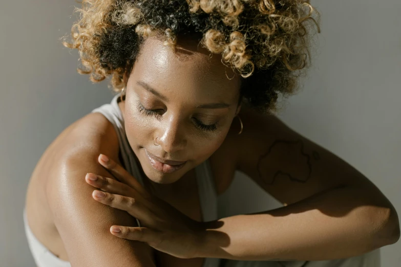 a woman wearing a white shirt is posing for a po