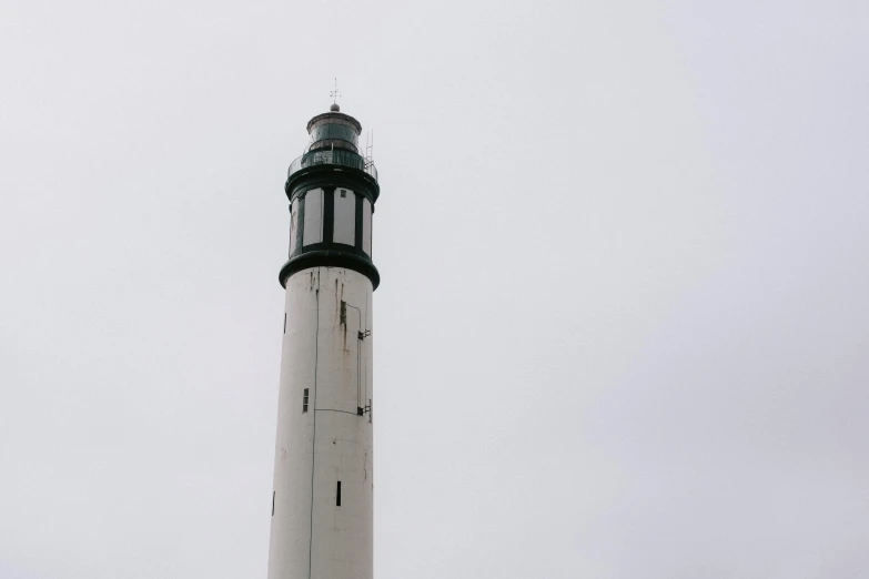 a po of a lighthouse on a foggy day