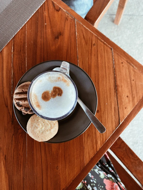 a cup of  chocolate on a plate with two ers