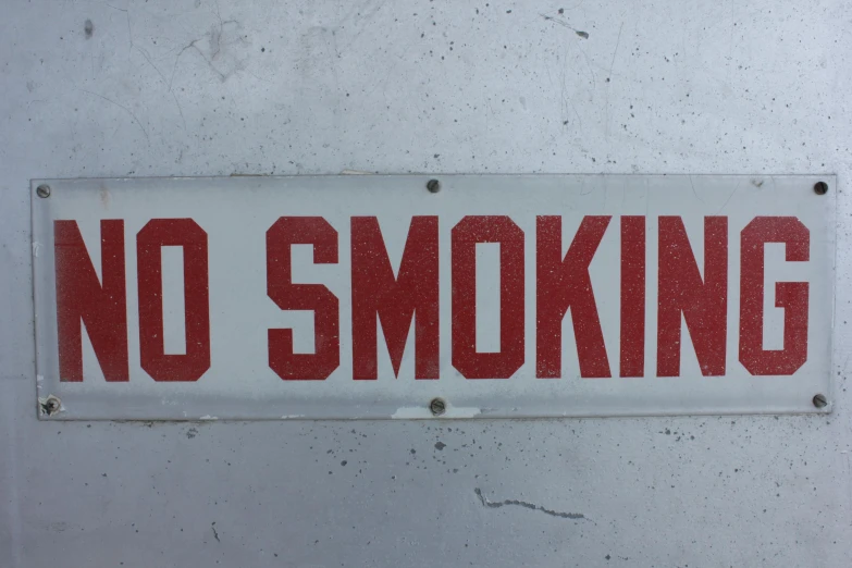 a sign that reads no smoking underneath it