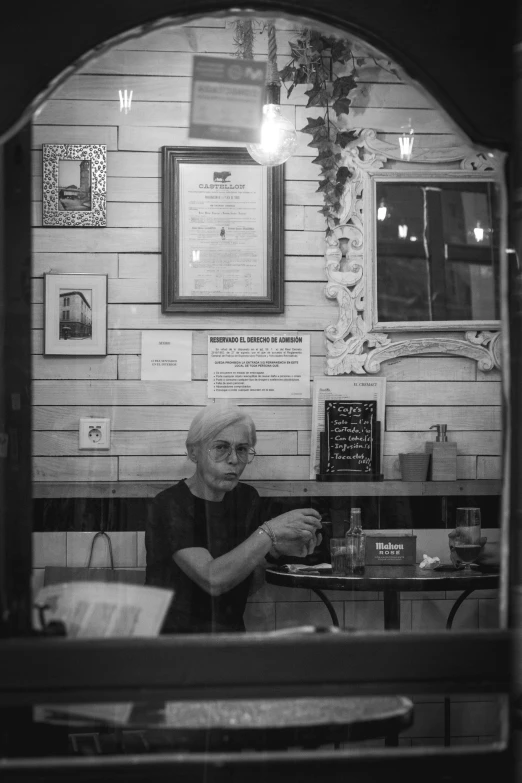 a person sitting at a table in front of a pizza hut