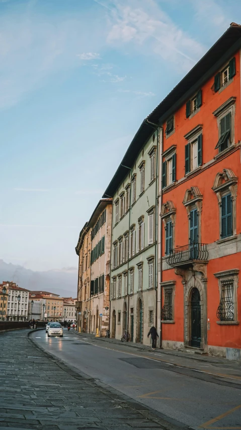 a big red and grey building next to a road